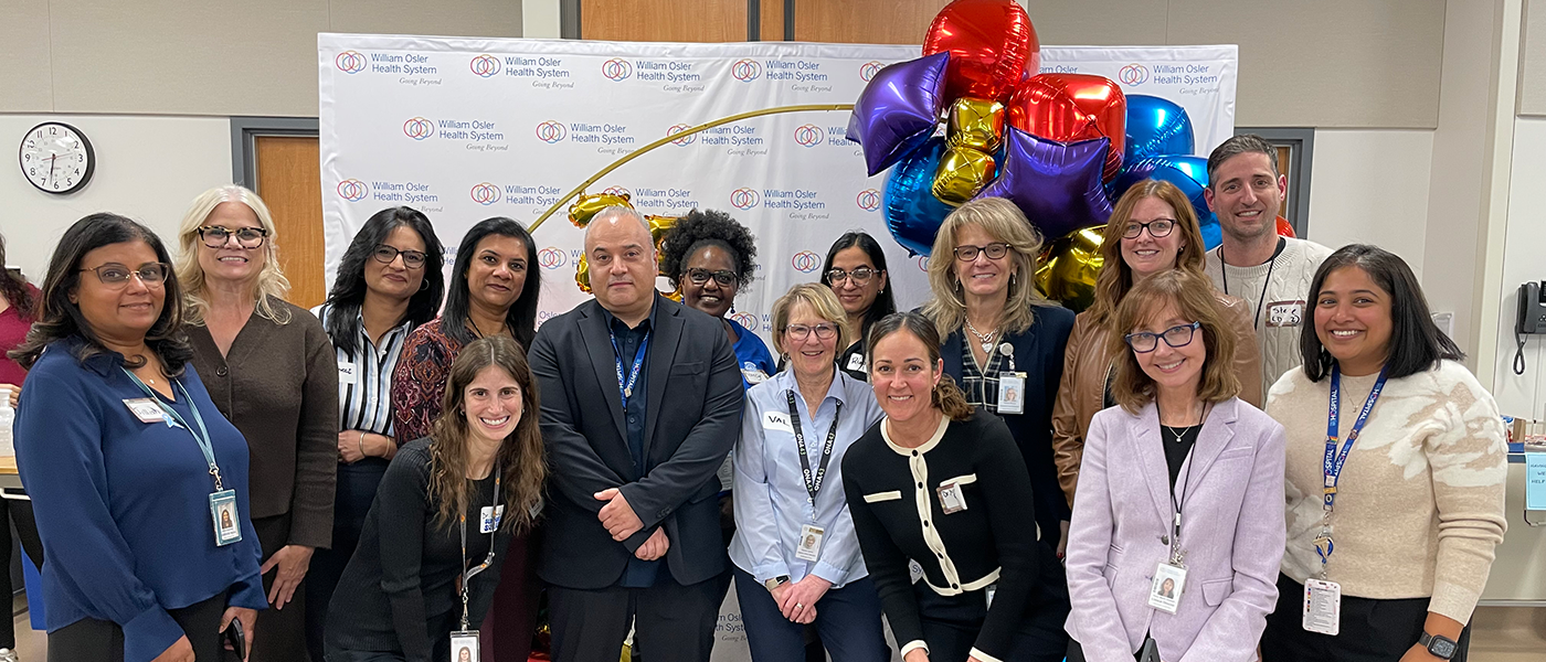 Osler’s Pediatric Diabetes team stand in a large group with ballons