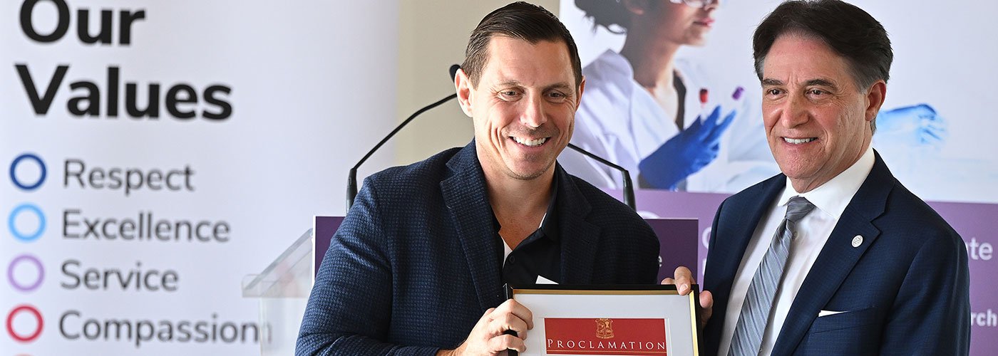 Mayor Patrick Brown (left) presents Dr. Frank Martino (right) with the proclamation for Celebrate Research Week in Brampton