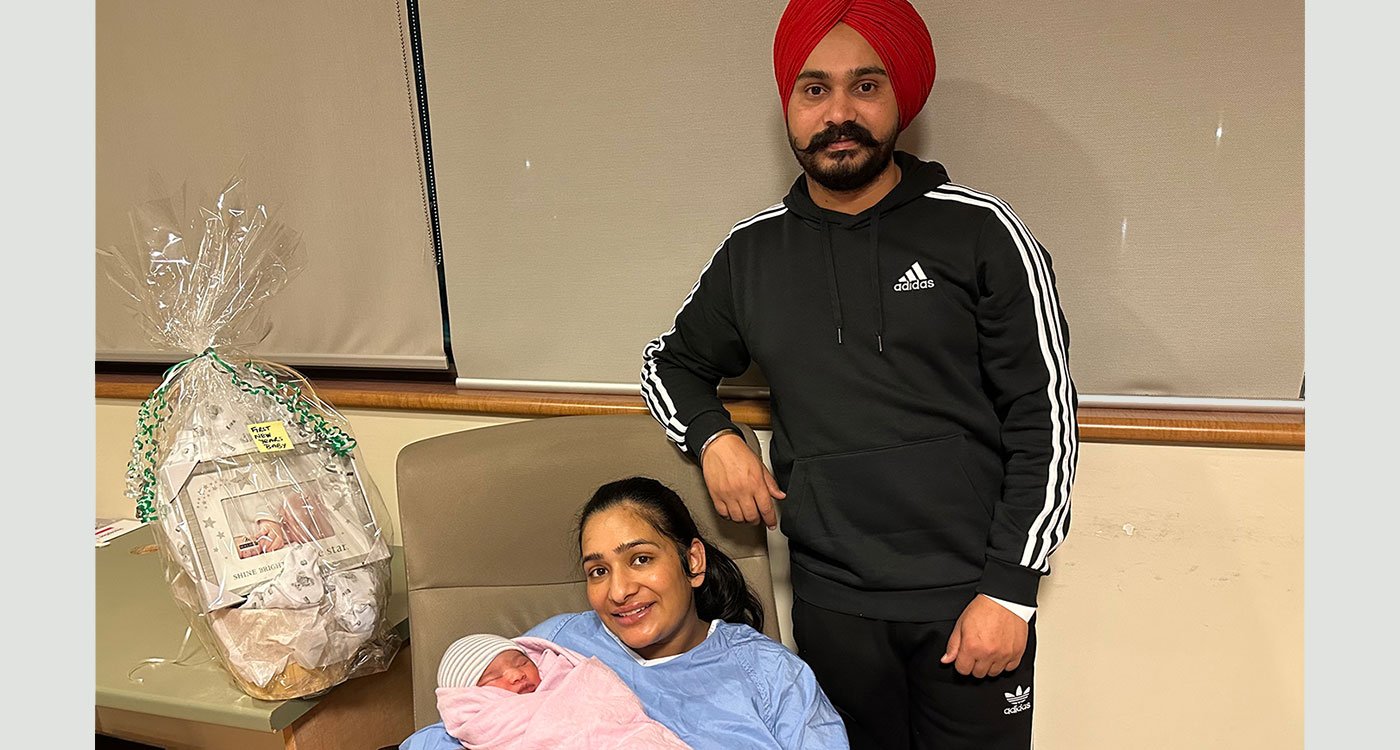 Proud parents hold their newborn baby girl