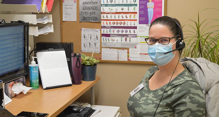 Chelsea Burnell, Telehomecare nurse at Osler, sits at her desk