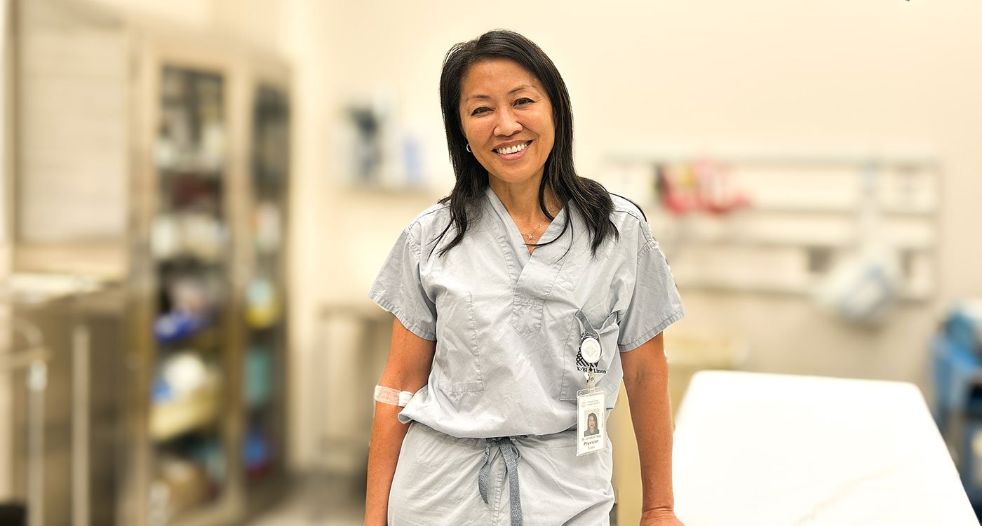 Dr. Christine Tang, Plastic Surgeon at Osler, poses in an operating room