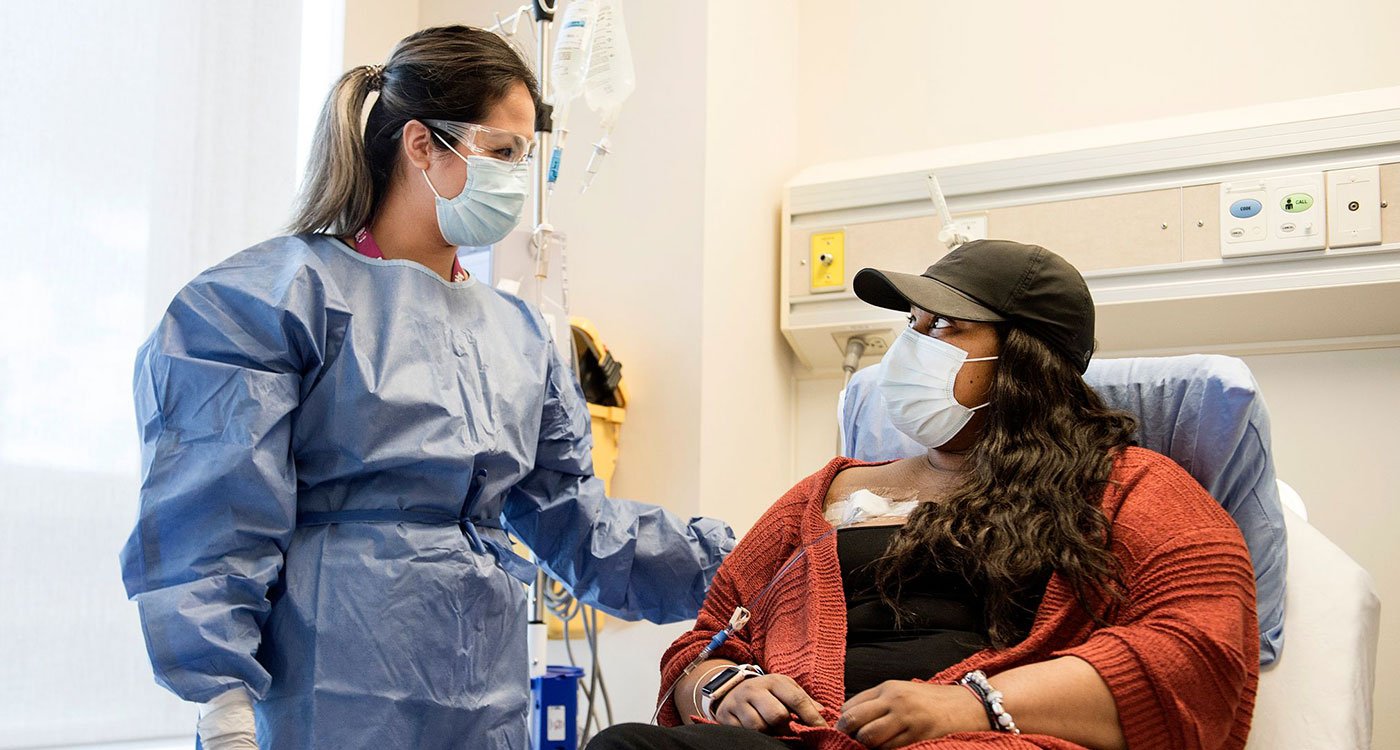 Osler clinician (left) assists patient (right) with chemotherapy treatment