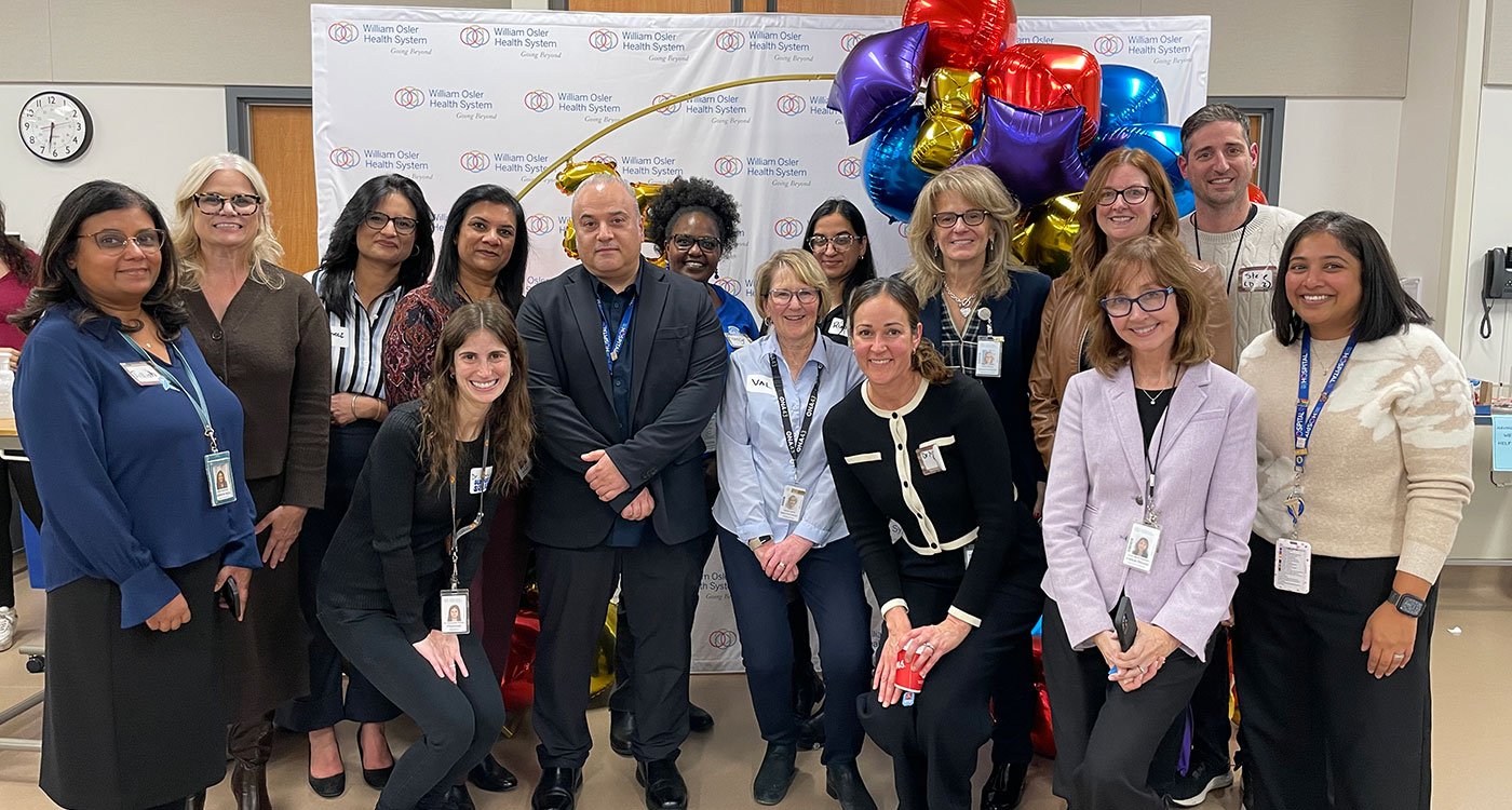 Osler’s Paediatric Diabetes team stand in a large group with balloons
