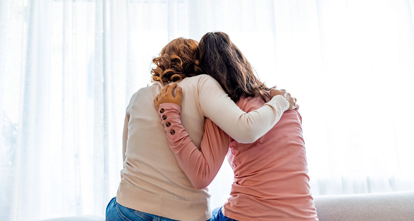 Backside of two women embracing