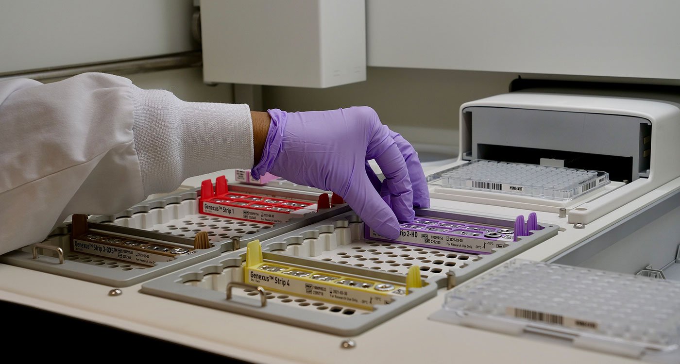 An Osler laboratory technician loads samples into the Next Generation Sequencing machine