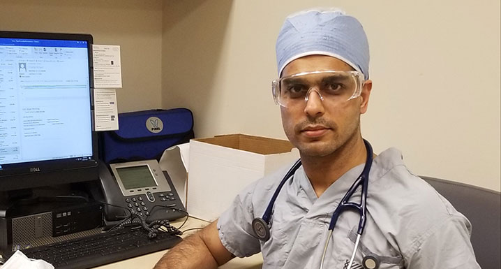 Dr. Rajat Kumar, a hospitalist at Osler’s Brampton Civic Hospital, sits at his desk