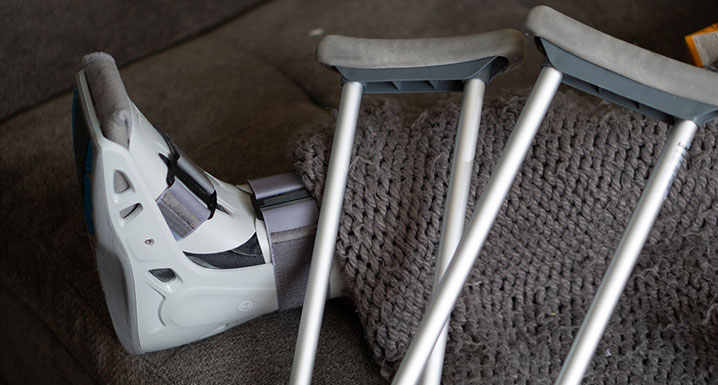 A set of crutches and a walking cast