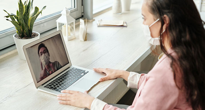 Two people video chatting with masks on