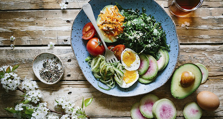 A salad with avocado, eggs and tomatoes