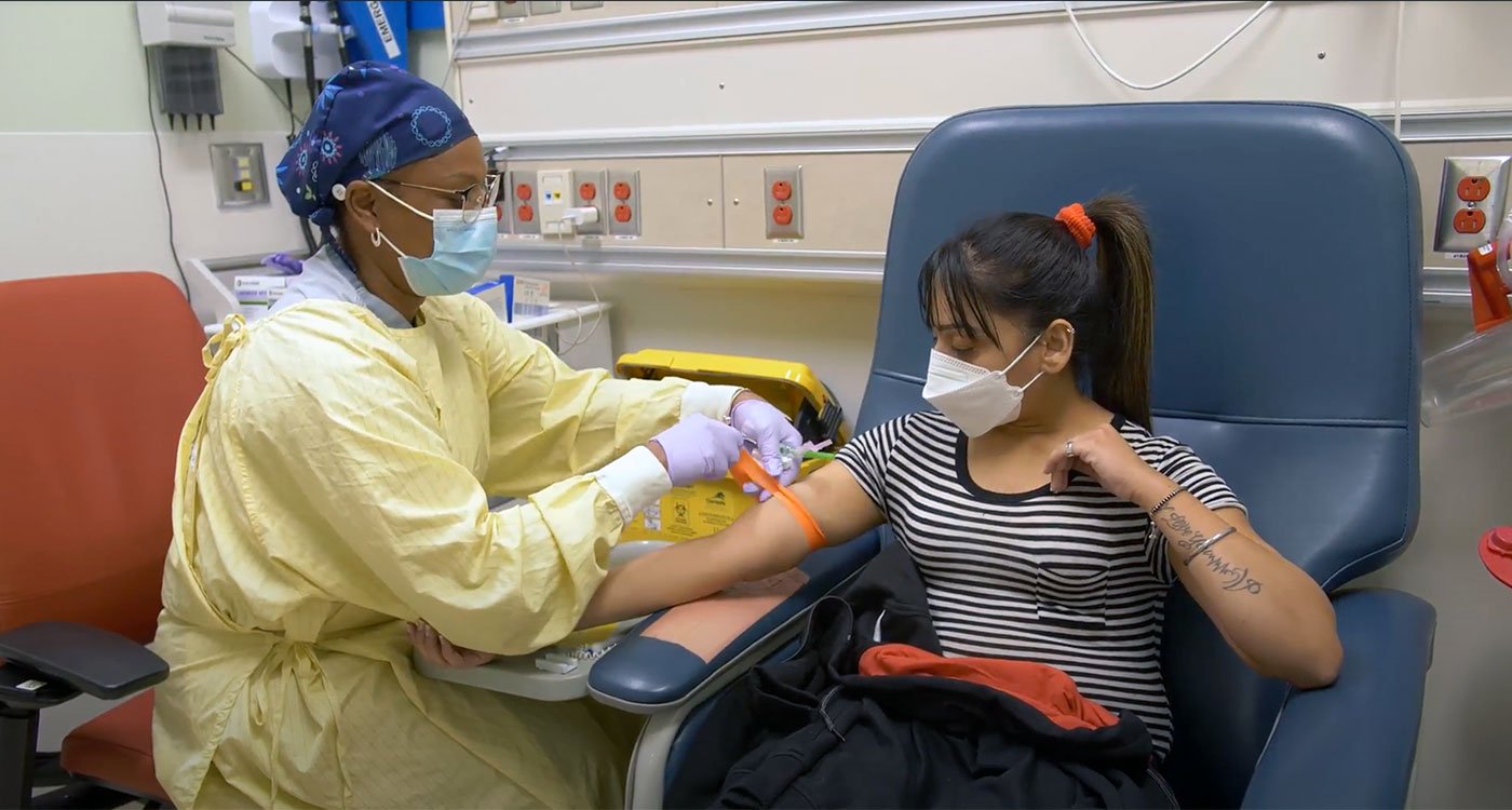 Clinician preps a patient for a needle