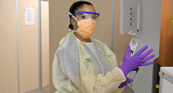 Osler staff member donning Personal Protective Equipment