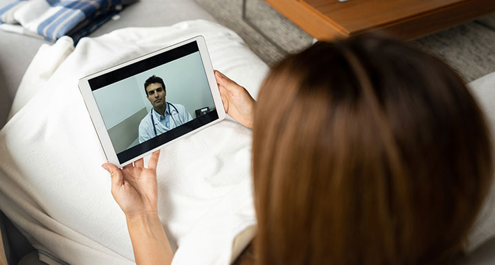 Patient using a device for a virtual chat with their physician