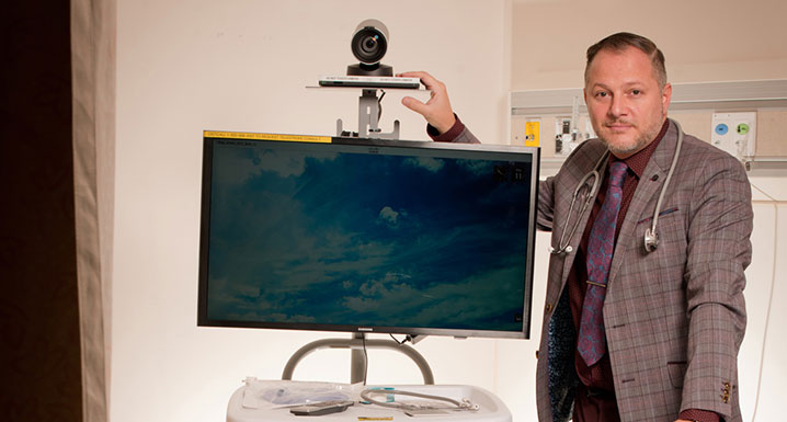 Osler physician with a virtual care camera and monitor stand