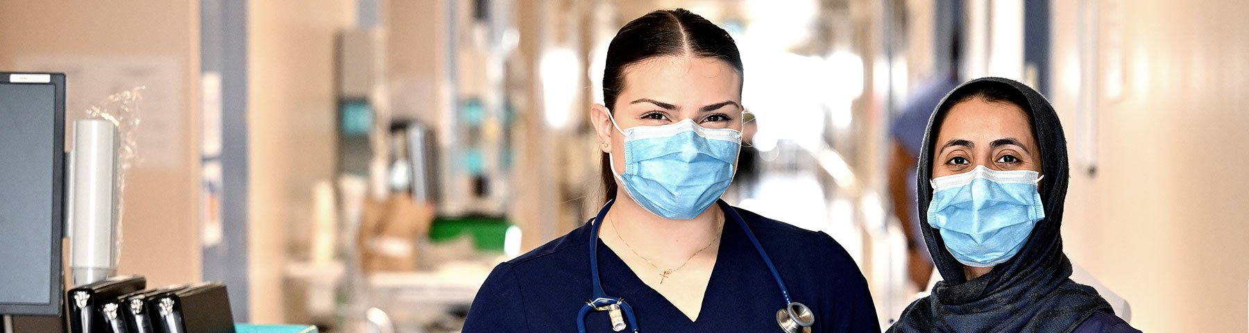 Two female clinicians stand in a hallway at Etobicoke General Hospital